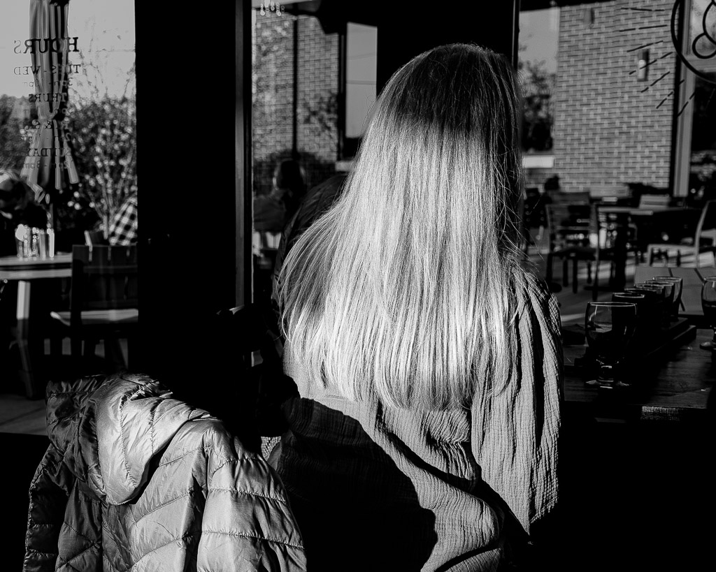 Woman with sun shining on hair at brewery. (Leica SL2, Sigma 35mm)